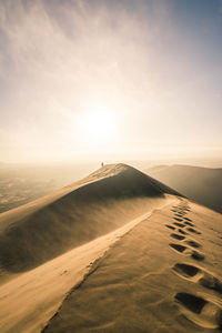 Scenic view of desert against sky during sunset