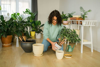 Rear view of woman with potted plant