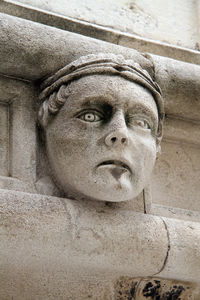 Close-up portrait of statue against wall