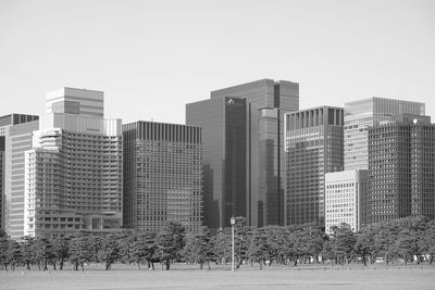 Modern buildings in city against clear sky