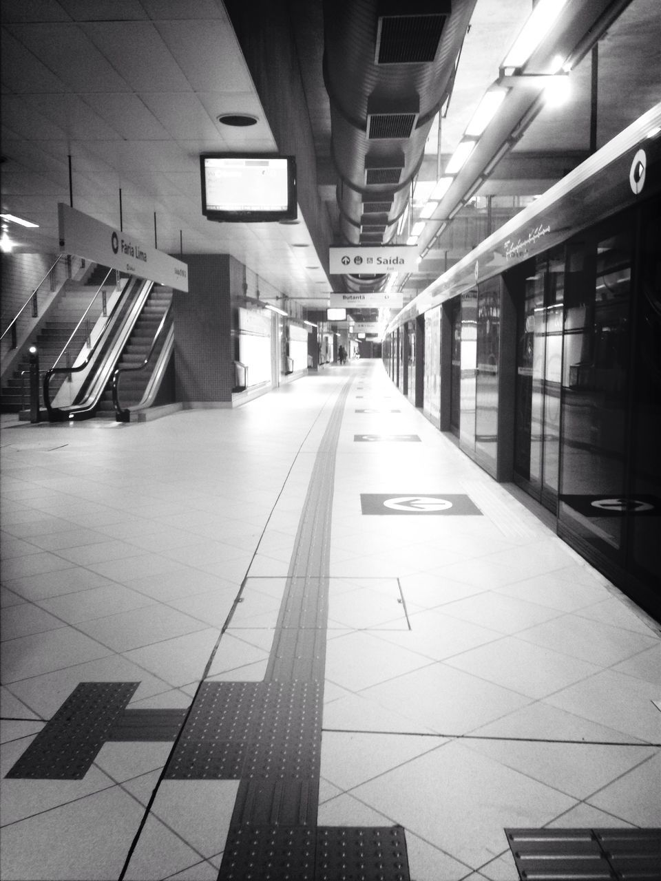 indoors, transportation, the way forward, illuminated, diminishing perspective, railroad station platform, built structure, architecture, public transportation, empty, railroad station, incidental people, rail transportation, subway station, vanishing point, ceiling, railroad track, subway, absence, public transport