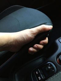 Close-up of hand in car
