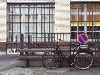 Side view of a bicycle against railings