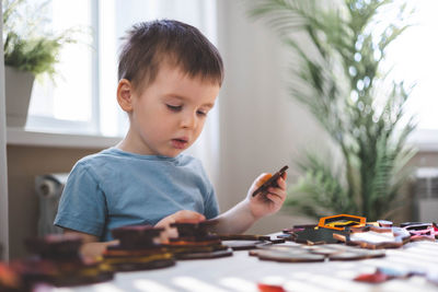 Boy playing with toy blocks at home