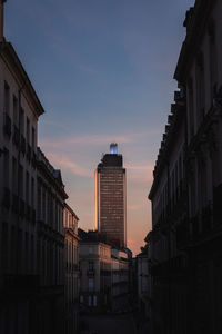 Low angle view of buildings against sky during sunset