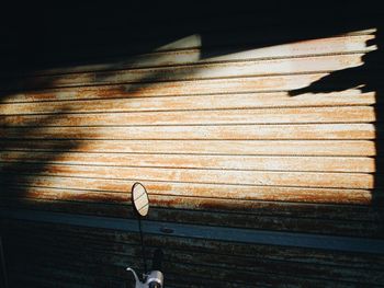 View of motorcycle handlebar against closed shutter