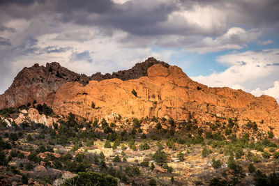 Scenic view of mountains against cloudy sky