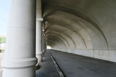 Empty corridor along pillars