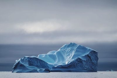 Close-up of snow on sea against sky