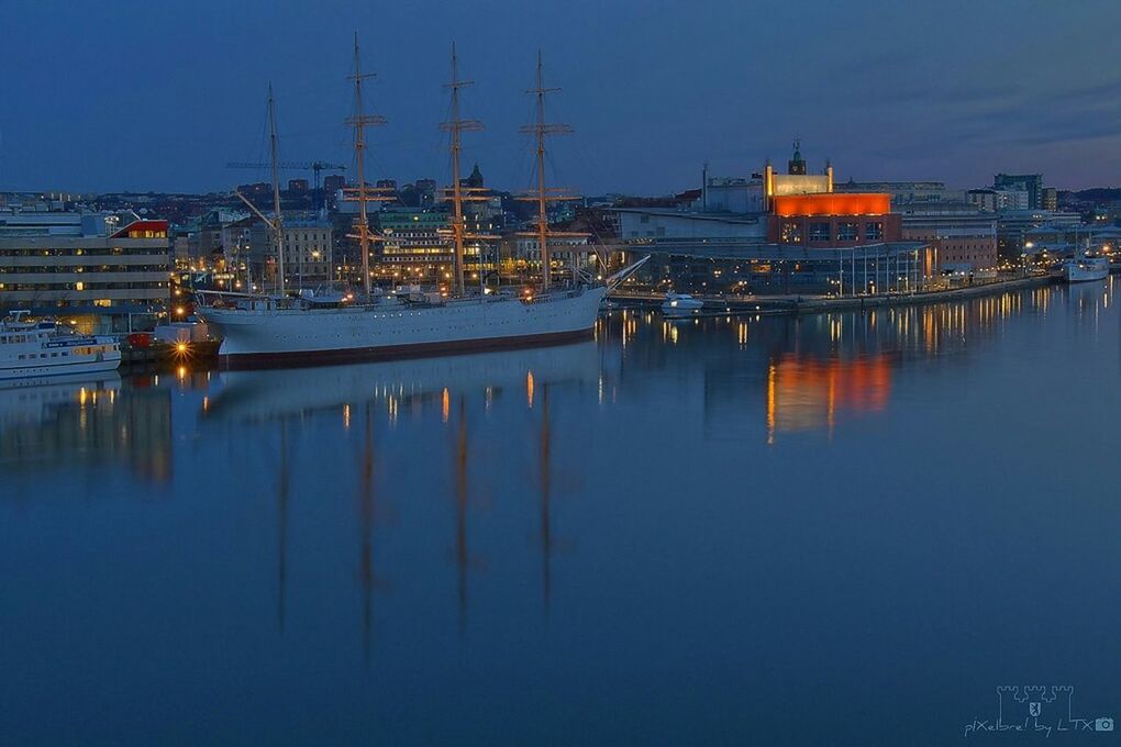 water, moored, reflection, nautical vessel, waterfront, harbor, boat, transportation, mode of transport, blue, sea, mast, marina, sailboat, sky, illuminated, lake, clear sky, dusk, no people