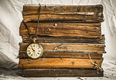 Close-up of clock on old books