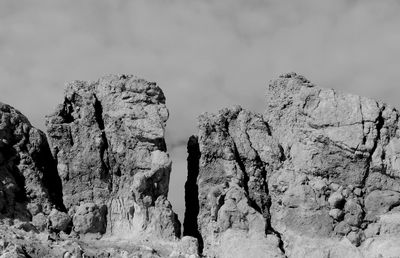 Low angle view of rocks against sky