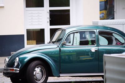 Vintage car parked against wall