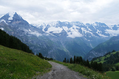 Scenic view of mountains against cloudy sky