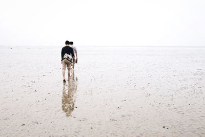 Silhouette of woman standing on beach