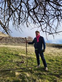 Low angle view of woman standing on tree