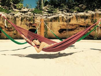 Girl relaxing on hammock at beach