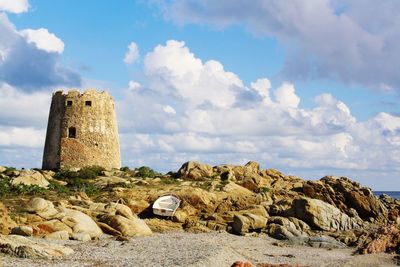 Tower on beach against sky