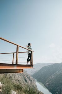 Man standing on mountain against sky