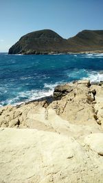 Scenic view of beach against clear sky