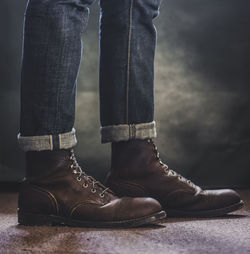 Low section of man wearing shoes standing outdoors