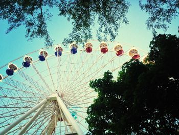 Low angle view of ferris wheel against blue sky