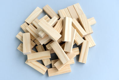 High angle view of stack of wood against white background