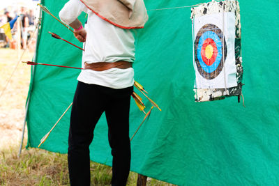 Rear view of woman standing on field