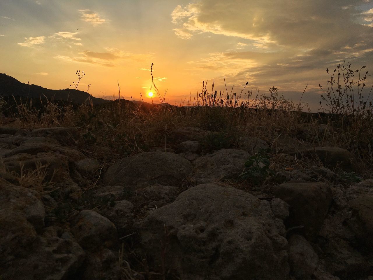 sunset, tranquil scene, tranquility, landscape, scenics, beauty in nature, sky, nature, sun, non-urban scene, cloud - sky, cloud, outdoors, orange color, majestic, atmosphere, no people, outline, rural scene, atmospheric mood, remote