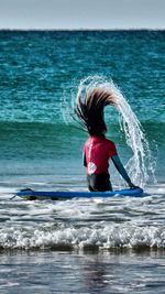 Rear view of woman in sea