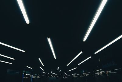 Low angle view of illuminated lights at night