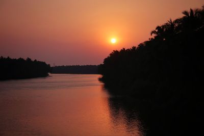 Scenic view of lake against romantic sky at sunset