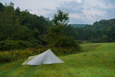 Tent in field against sky