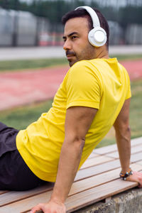Portrait of man exercising on field