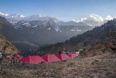 Tent on snow covered field against sky
