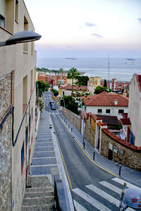 High angle view of townscape by sea against sky