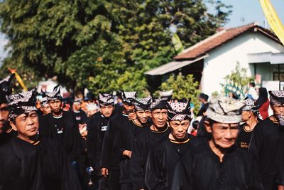 Group of people in traditional clothing standing outdoors