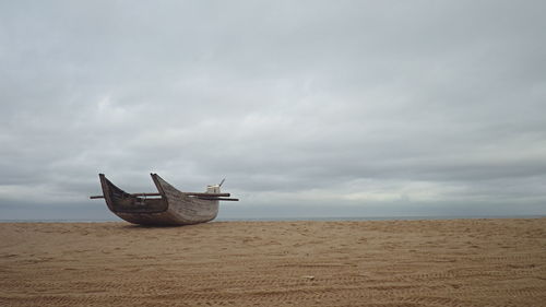 Boat on beach against sky