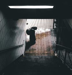 Rear view of woman walking in corridor