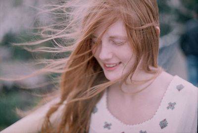 Close-up of happy beautiful woman standing outdoors