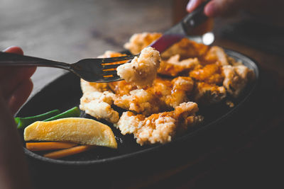 Cropped hands having food