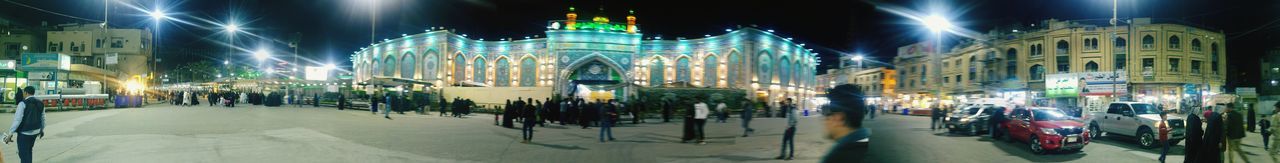 Panoramic view of city street at night