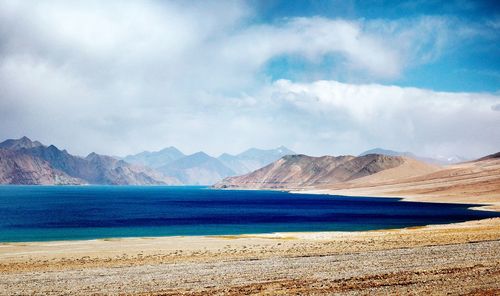 Scenic view of landscape and mountains against sky