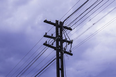 Low angle view of electricity pylon against sky