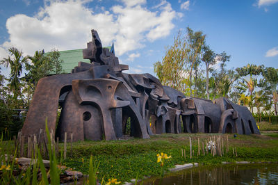 Built structure by lake against sky
