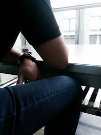 Low section of woman sitting on tiled floor