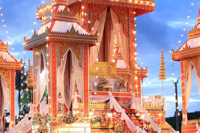 Low angle view of illuminated building against sky at dusk