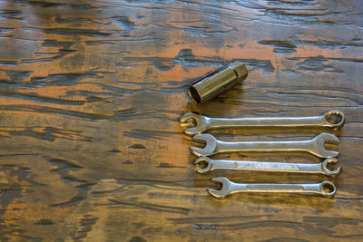 Directly above shot of spanners on wooden table