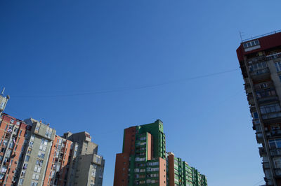 Low angle view of buildings against blue sky