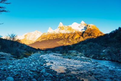 Scenic view of mountain against blue sky